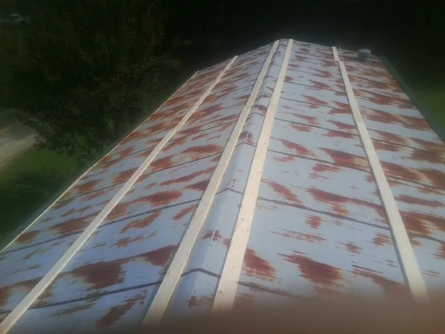 Rusted metal roof panels with new wood purlins before replacement — Storm Damage Roof Repair in Barnardsville by Roofing Brothers